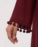 The Zeina Pom-Pom Cuff Abaya, in Burgundy, detail view