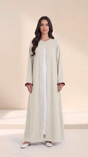 The Zeina Pom-Pom Cuff Abaya, in Off White, front view