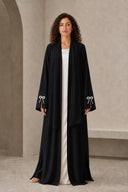 The Sakina Pearl Bow Cuff Abaya, in Black, front view
