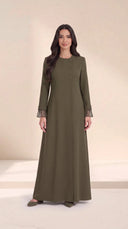 The Sundus Asymmetric Button Abaya, in Green, front view