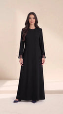 The Sundus Asymmetric Button Abaya, in Black, front view