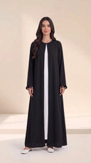 The Zeina Pom-Pom Cuff Abaya, in Black, front view