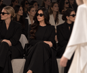 Woman wearing The Afroz Asymmetric Panel Tailored Abaya seated front row at a fashion show