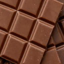  Close-up of milk chocolate bars in rich cocoa brown tones, inspired by the chocolate brown abaya color trend.