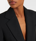 Close-up of a black tailored lapel highlighting the structured notch collar and sharp blazer-inspired lines