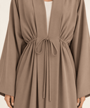 Close-up of a taupe tie-front abaya The Fatima Gathered Waist Tie Abaya