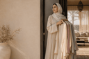 Modest fashion lady in an abaya holding abayas