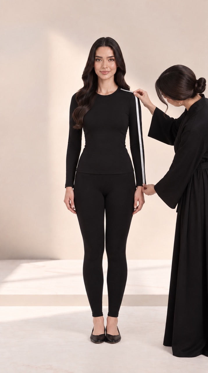Measuring sleeve length from shoulder to wrist, with a helper