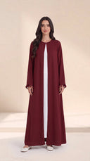 The Zeina Pom-Pom Cuff Abaya, in Burgundy, front view