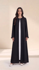 The Zeina Pom-Pom Cuff Abaya, in Black, front view