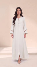 The Rimas Frog Button Front Abaya, in Off White, front view