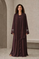 The Sakina Pearl Bow Cuff Abaya, in Burgundy, front view
