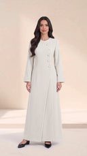The Samira Curved Asymmetric Button Abaya, in Off White, front view