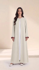 The Zeina Pom-Pom Cuff Abaya, in Off White, front view